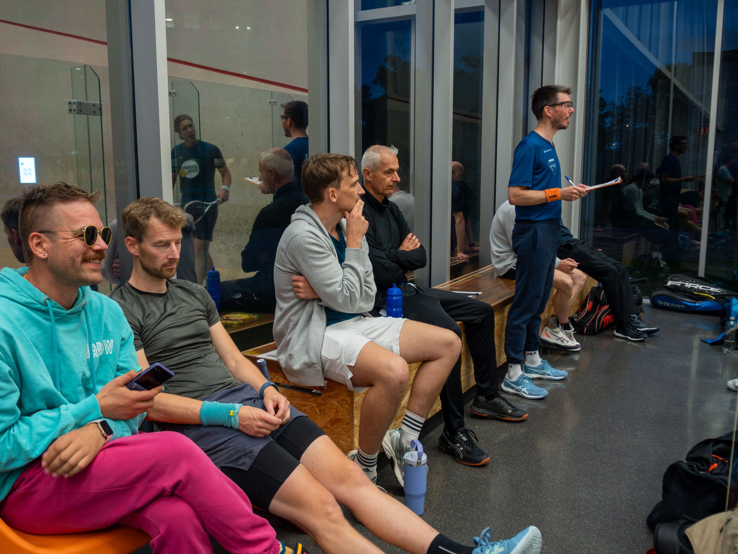 SCHIET players and spectators beside a squash court on opening night.