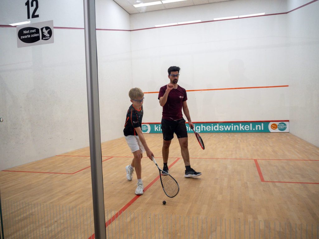 Two players reposition on court between shots.