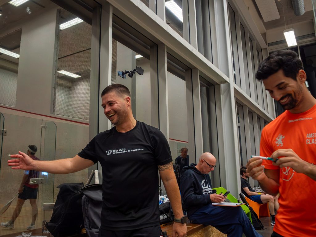 Two players sharing a smile beside the court.