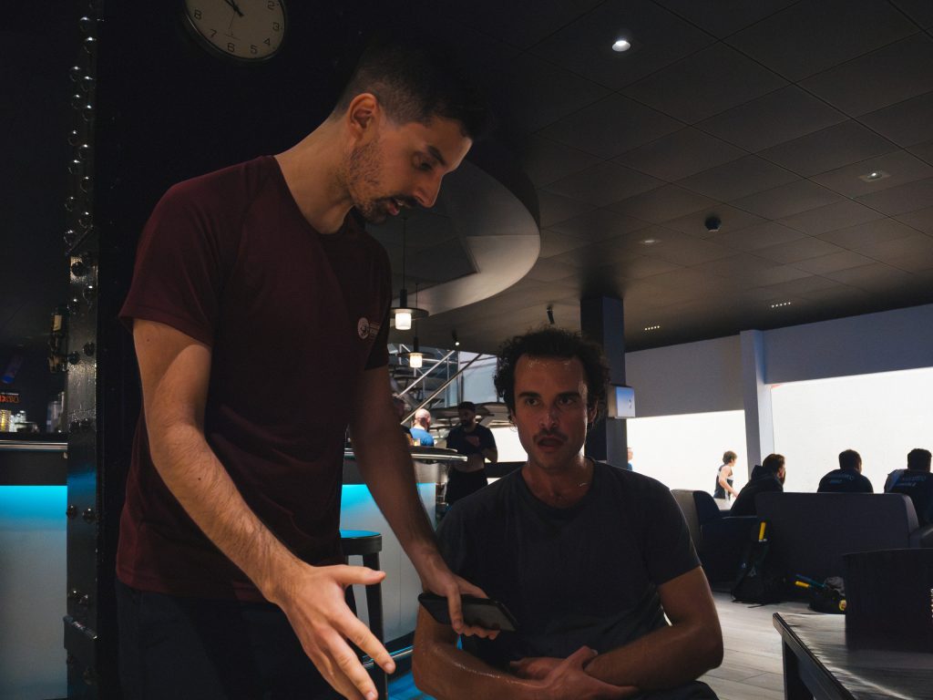 Two players talking beside the squash courts after a match.
